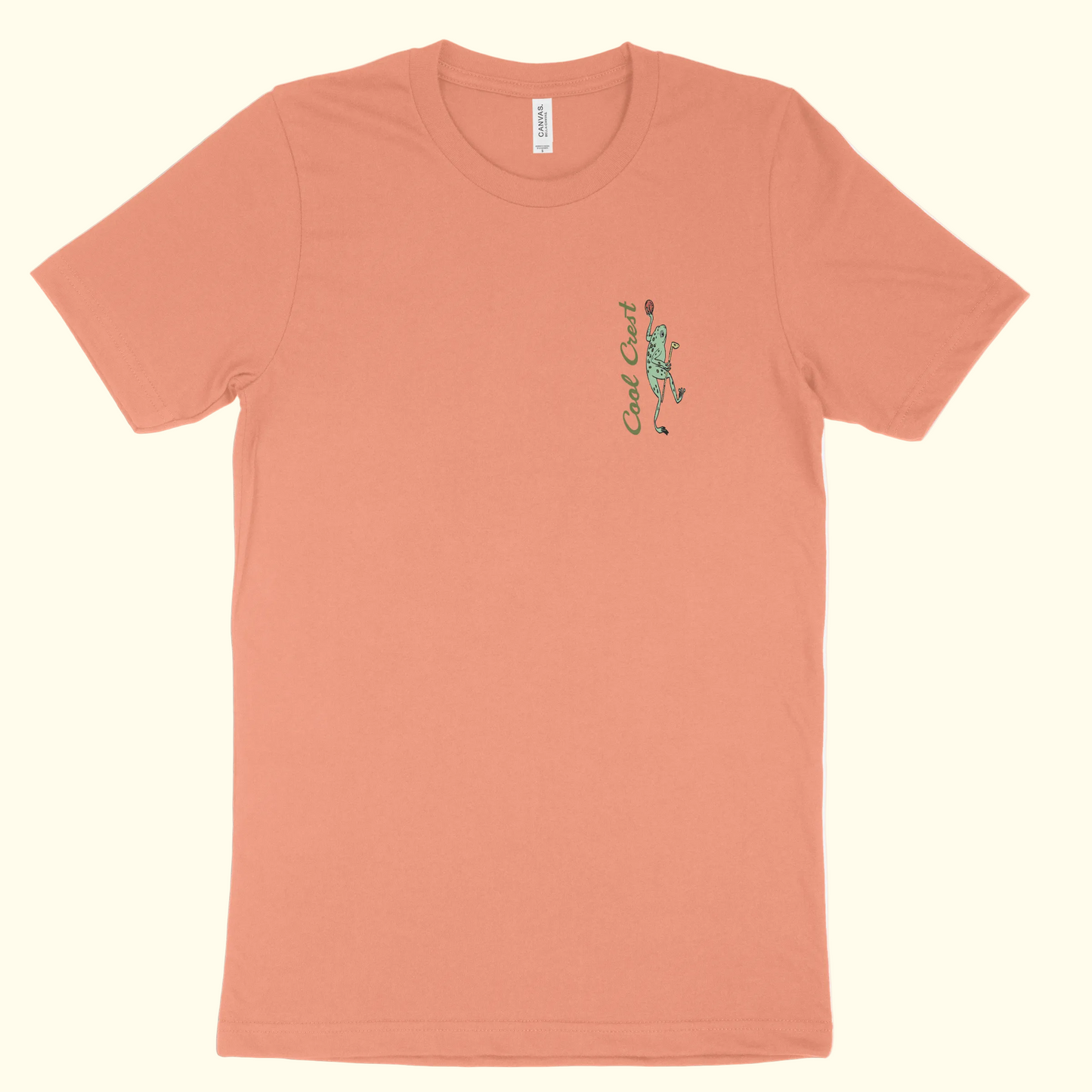 Peach-colored t-shirt with a green graphic on a white background